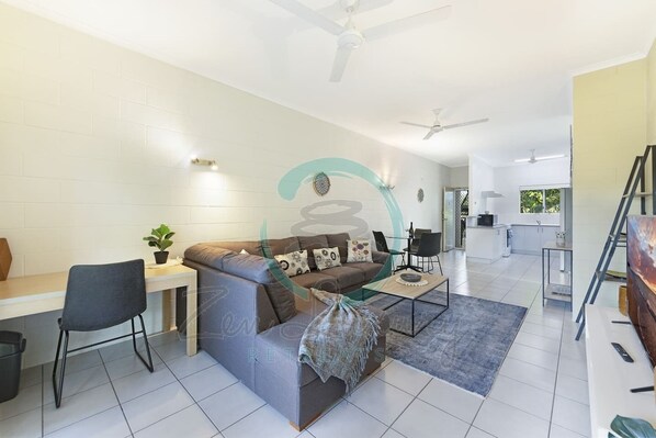 ZEN Westralia: 2-BR Cozy Inner-City Apt Near Shops - Unwind in our cozy living room, where plush sofas and warm ambiance invite you to relax and recharge.