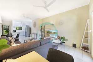 ZEN Westralia: 2-BR Cozy Inner-City Apt Near Shops - Our living room is your entertainment hub, complete with a smart TV, cozy seating, and board games for endless fun."