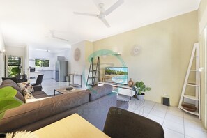 ZEN Westralia: 2-BR Cozy Inner-City Apt Near Shops - Our living room is your entertainment hub, complete with a smart TV, cozy seating, and board games for endless fun."