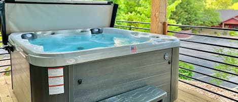 Relax in the warm hot tub and surrounded by lush greenery 