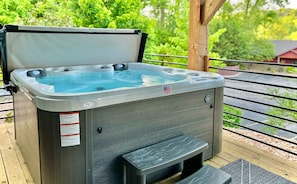 Relax in the warm hot tub and surrounded by lush greenery 