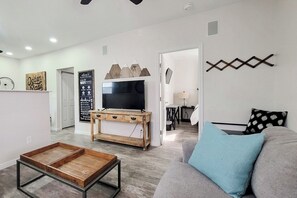 Living area with a view of the TV and Master Bedroom to the right.