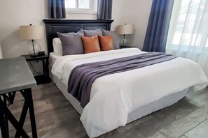 Master bedroom with soft and cozy king size bed. The drapes are blackout drapes so you can get a good night's sleep.
