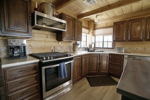 Stocked kitchen includes fridge/freezer, 4 gas burner stove, oven, dishwasher