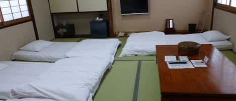 In the room, futons are laid out at check-in.