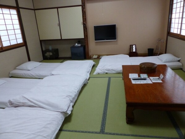 In the room, futons are laid out at check-in.