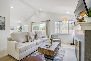 Living Room with Decorative Fireplace and HDTV