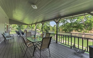 The large back porch has plenty of seating area available for all of your guests.