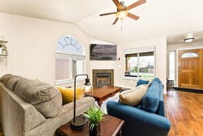 The front room is inviting and open. The grey sleeper sofa has a queen bed.