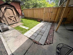 Outdoor fenced in area with a table and 4 chairs.