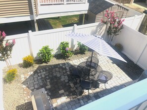 Private backyard patio with natural gas grill and outdoor shower
