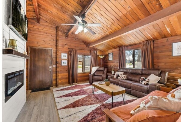 Relax surrounded by red cedar logs, vaulted ceilings, and12-foot fireplace. 