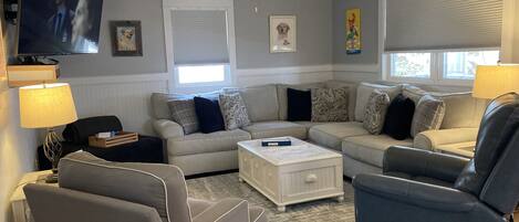 A large, comfy sectional sofa provides plenty of seating for the whole family. 
