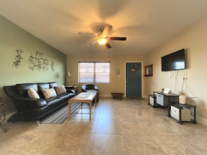 Full view of living room and entrance from kitchen. 