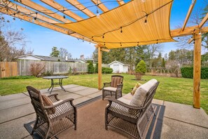 Outdoor sitting area with spacious lawn and garden