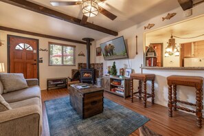 Open floor plan with cozy fireplace and 65" smart TV