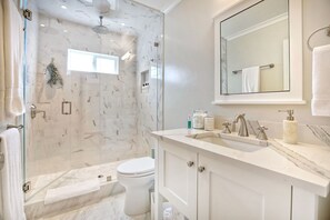 Full bathroom with rain shower head in shower.