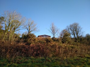 The cabin seen from the valley below