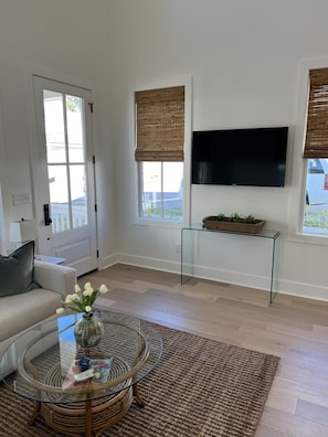 Living room complete with smart tv and lots of natural light. 