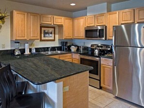 Gourmet kitchen with granite countertops, fully stocked with kitchen essentials!