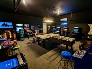 Arcade room with air hockey, foosball, and full size arcade machines