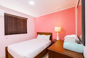 An air-conditioned bedroom with comfortable bed