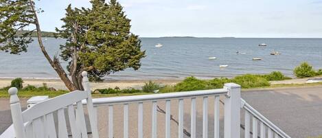 View of the beach from the front porch with outdoor furniture