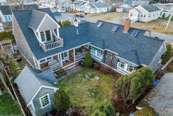 Aerial view of the private courtyard with patio furniture and shed full of beach toys, beach chairs, and yard games