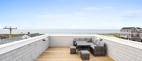 Gorgeous ocean views from the roof deck with outdoor lounge furniture.  The walls are nice and high to ensure safety.