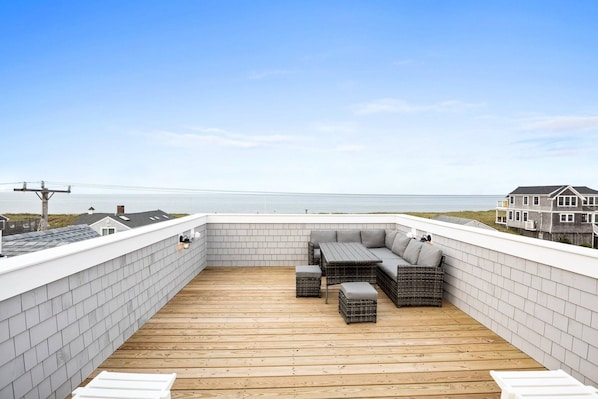 Gorgeous ocean views from the roof deck with outdoor lounge furniture.  The walls are nice and high to ensure safety.