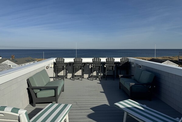 Gorgeous ocean views from the roof deck with outdoor lounge furniture.  The walls are nice and high to ensure safety.