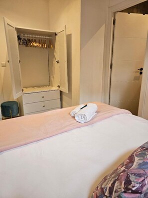 The wardrobe in the bedroom with hangers and drawers
