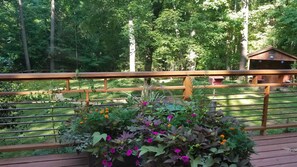 View from the back deck to backyard, woods, shed, and shed deck