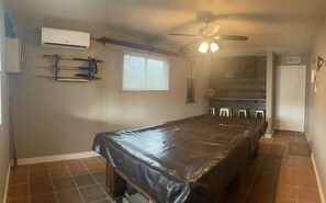 Pool table with tv and dart board 