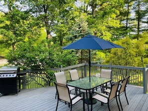 Enjoy grilling and outdoor dining on the large deck, surrounded by nature.