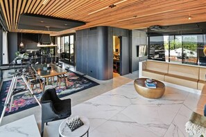 Open plan living level designed by Izzard Design provides booth seating to watch sports on the drop down 3.5M projector screen. Note the lockable concealed bar with full size icemaker fridge-freezer.
All lights are dimmable.