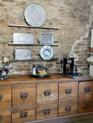 The antique cabinet supports a fully stocked coffee bar for our guests.