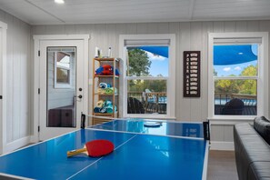 Challenge your family and friends to ping pong and then cool down in the pool.