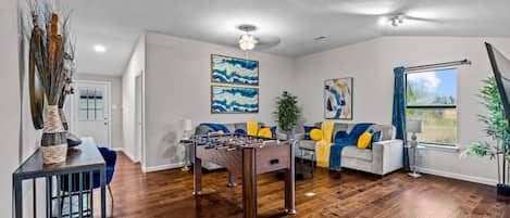 Unwind and reconnect in this inviting living room, the ultimate hub for entertainment and relaxation. Challenge your friends and family to an epic foosball match, or cuddle up on one of the two plush couches for a cozy Netflix binge. This versatile space 