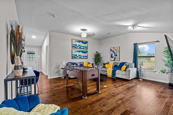 Unwind and reconnect in this inviting living room, the ultimate hub for entertainment and relaxation. Challenge your friends and family to an epic foosball match, or cuddle up on one of the two plush couches for a cozy Netflix binge. This versatile space 