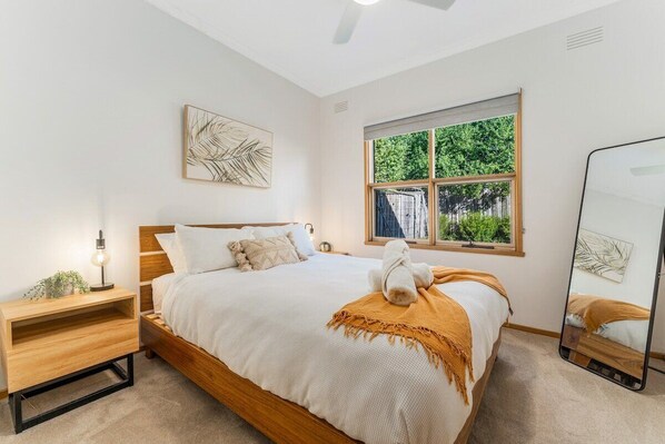 Bedroom with queen bed and garden views