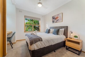Bedroom with queen bed and ample storage