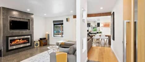 The sunken lounge area with polished concrete floors adds a touch of sophistication and comfort