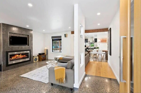 The sunken lounge area with polished concrete floors adds a touch of sophistication and comfort