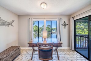 The master bedroom features a King size bed, dedicated workspace, flat screen television, ensuite bathroom, and views of Grand Lagoon.