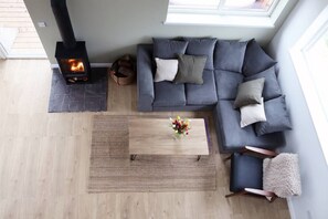 Livingroom area with wood burning stove and underfloor heating.