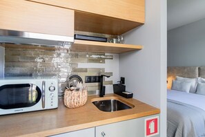 Nicely equipped kitchenette with a coffee machine, toaster, stove, kettle, and a microwave for your quick meals! #kitchen #cooking