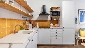 Kitchenette comes equipped with a toaster, coffee machine, kettle, microwave and stove #kitchen