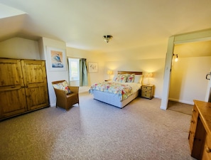 Bedroom two: Double bed, wardrobe, drawers, sink and views of the fields