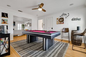 Bar stools, pool table, SONOS speaker and record player in our game room!